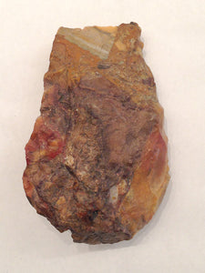 A colorful, N. African cleaver, laid out flat, showing great density and heft